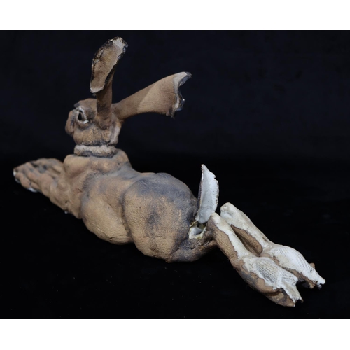 44 - A large Studio glazed earthenware figure of a resting Hare (Both back legs restored), 59.5cm long, 2... 