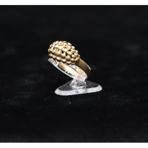 442 - A 9ct gold cluster ring with raised ball and pierced decoration, Size R/S, 3.6 grams