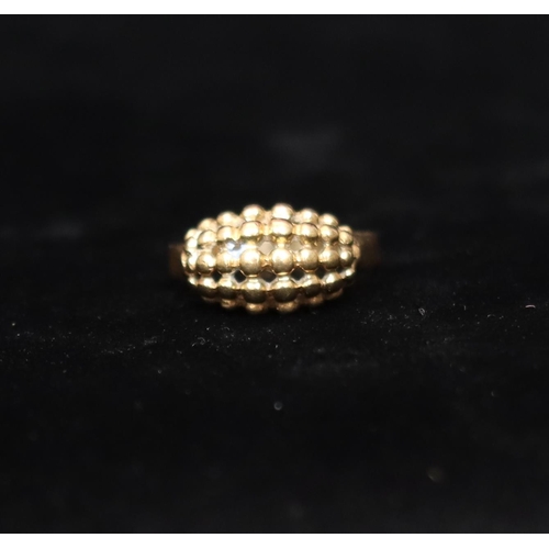 442 - A 9ct gold cluster ring with raised ball and pierced decoration, Size R/S, 3.6 grams