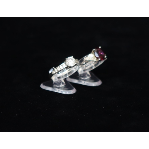 445 - A 9ct white gold ladies' ring set with clear stone flanked by smaller stones to shoulders, Size O, a... 