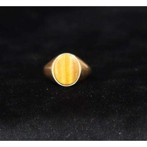 455 - A 9ct gold gentlemen's oval Tiger's Eye signet ring, Size P, 2.3 grams gross