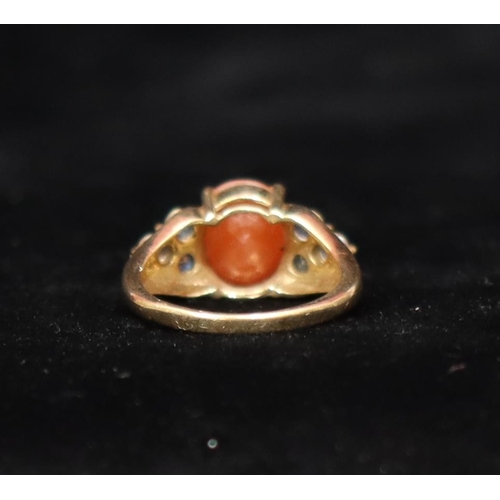 458 - A 9ct gold cluster ring set with centre orange stone flanked by clear stones, Size P, 4.3 gram gross