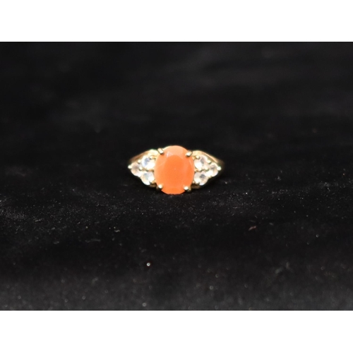 458 - A 9ct gold cluster ring set with centre orange stone flanked by clear stones, Size P, 4.3 gram gross