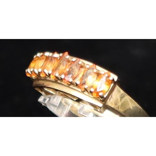 459 - A 9ct gold ladies' ring set with various orange stones, Size O/P, 3.6 grams gross