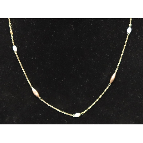 463 - A 9ct gold chain mounted with 5 pearl style beads, 44.5cm long, 2.9 grams gross