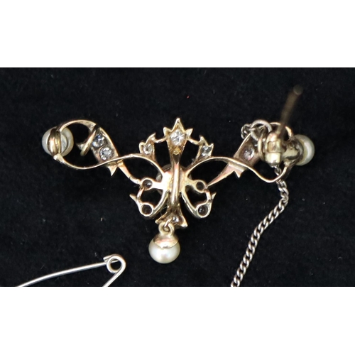 466 - A 14ct gold brooch with 4 pearls interspersed by small diamond chips, 3.8cm wide, 4.9 grams gross