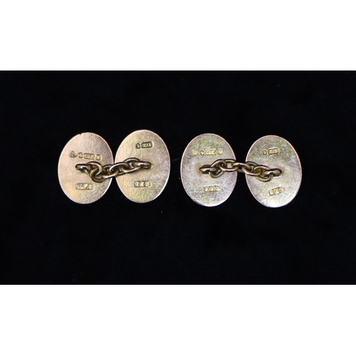 475 - A pair of 9ct gold oval gentlemen's cufflinks with chased and scroll decoration, 4.9 grams