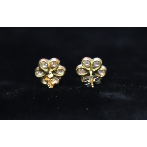 483 - A pair of 18ct gold cluster earrings set with centre diamond, surrounded by 6 further diamonds, each... 