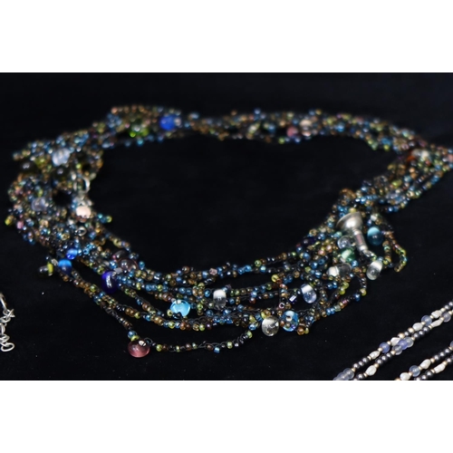 485 - A multicoloured bead necklace and matching bracelet, a pearl and bead necklace and a cultured pearl ... 