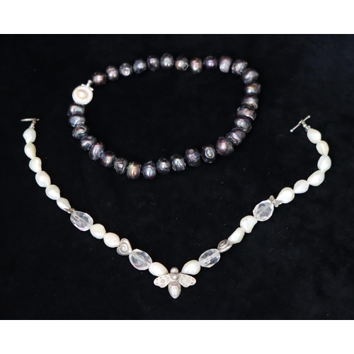 486 - A modern silver and large cultured pearl necklace with B motif, a modern black cultured pearl bead n... 