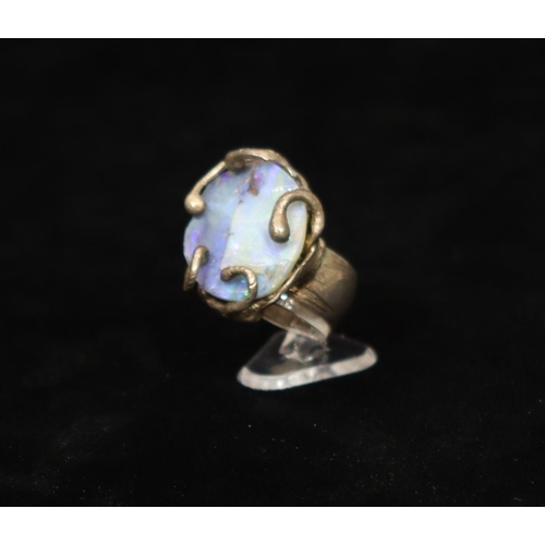 494 - An unusual silver ring with oval stone and allover raised scroll rim, Size M, 17.2 grams gross