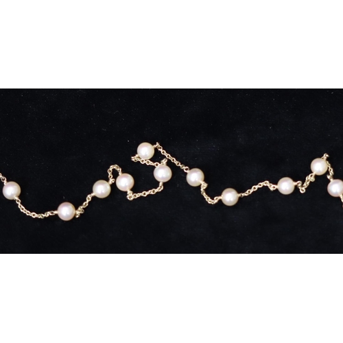 502 - A 9ct gold and cultured bead long necklace, 122cm long, 21.5 grams gross,