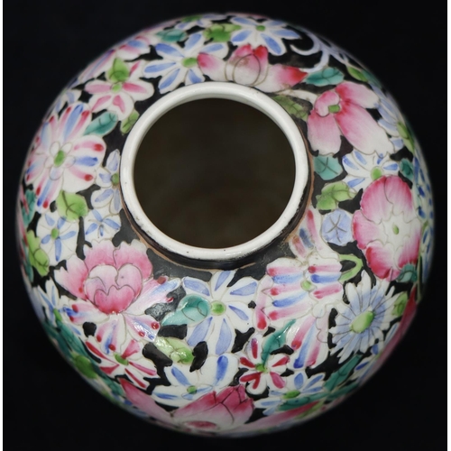 51 - An Oriental round bulbous thin neck vase on black ground with multicoloured floral and leaf decorati... 