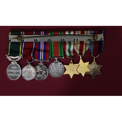 562 - A bar of 7 WWII medals, 1939/45 medal, Defence medal, Territorial Army Efficient Service medal 
