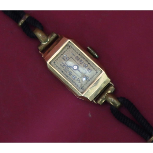 565 - A 14ct gold ladies' wristwatch with Arabic numerals, leather strap bracelet, weight excluding moveme... 