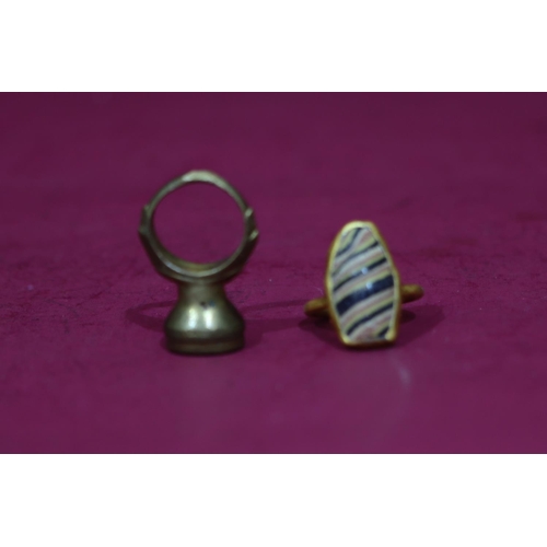 590 - An ancient style gilt metal ring set with striped stone, Size S/T, a similar ancient style ring set ... 