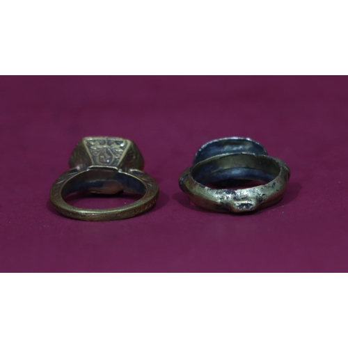 591 - An ancient style signet ring with figure motif, Size Q/R, a similar ring set with carved stone, Size... 