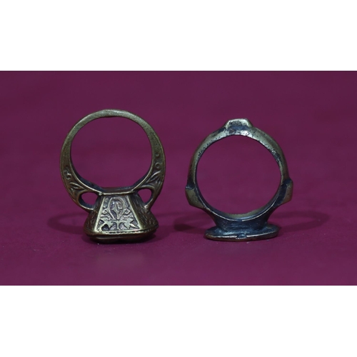 591 - An ancient style signet ring with figure motif, Size Q/R, a similar ring set with carved stone, Size... 