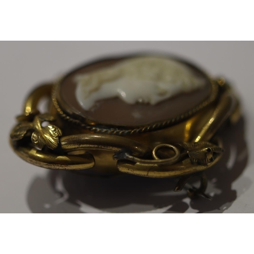 602 - A 19th Century oval mourning brooch with twist centre, depicting cameo figurehead of a lady with gla... 