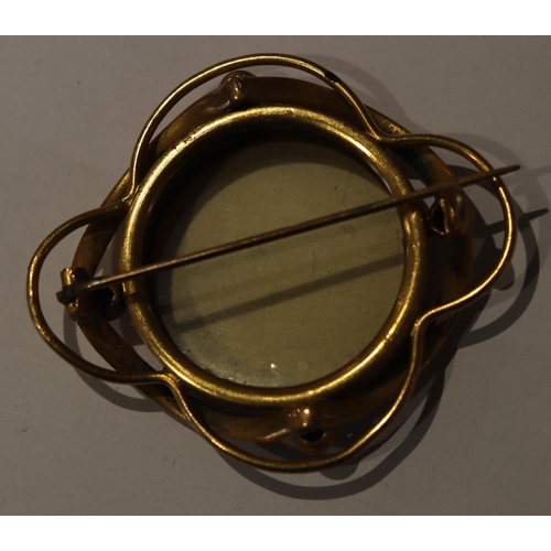 603 - A late 19th Century brooch with circular centre with glass panel and ball rim, 5.3cm wide