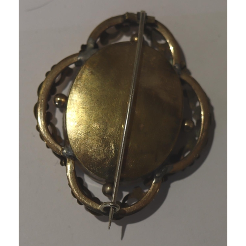 613 - An oval mourning brooch with black enamel centre 