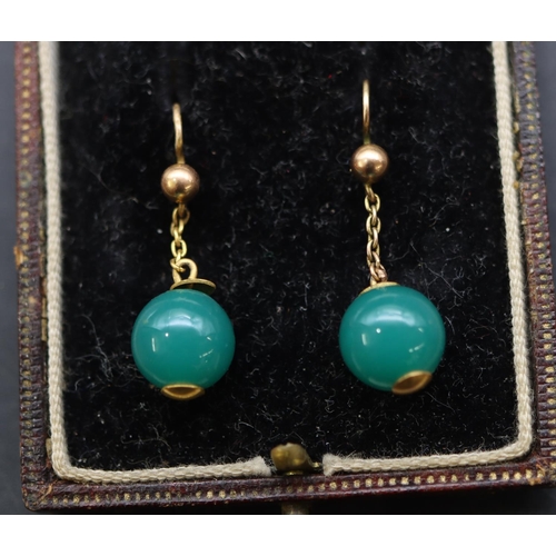 684 - A pair of gold and green hardstone ball shaped drop earrings, in fitted leather case