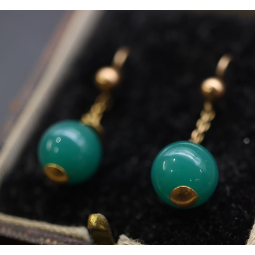 684 - A pair of gold and green hardstone ball shaped drop earrings, in fitted leather case