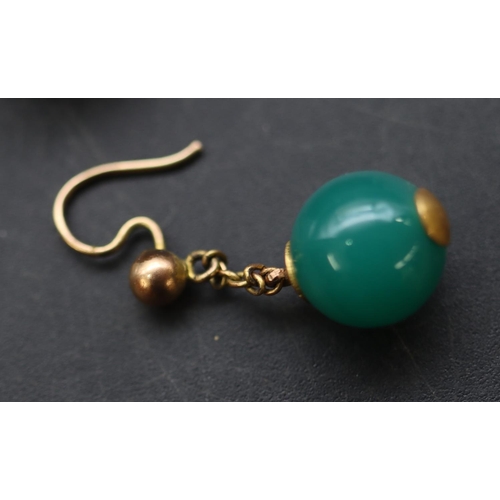 684 - A pair of gold and green hardstone ball shaped drop earrings, in fitted leather case