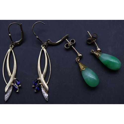 693 - A pair of gold and jade drop earrings and a pair of gold earrings mounted with small sapphires (4)