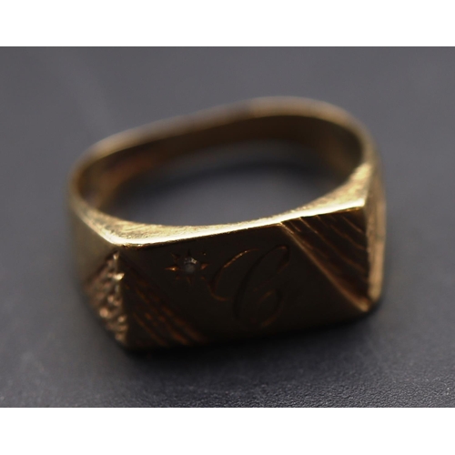 697 - A 9ct gold gentlemen's signet ring set with small diamond (shank dented), Size Q/R, 4 grams gross