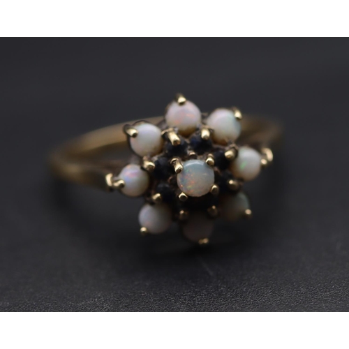 698 - A 9ct gold cluster ring set with opals and small blue stones, Size S/T, 3.4 grams