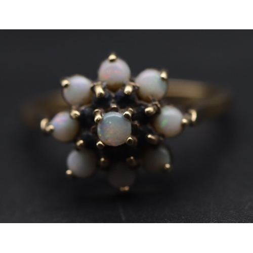 698 - A 9ct gold cluster ring set with opals and small blue stones, Size S/T, 3.4 grams