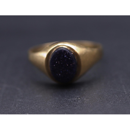 699 - A small gold signet ring set with oval glittering blue stone, Size L, 1.2 grams