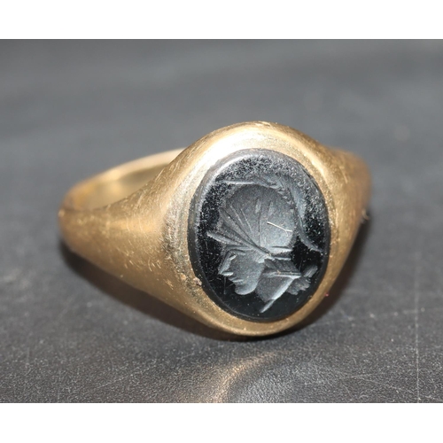 701 - A 9ct gold oval signet ring set with figurehead of a gentleman, Size T, 4.6 grams gross