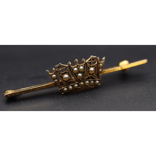 704 - A 9ct gold bar brooch mounted with crown motif, inset with half pearls, 3.9 grams gross