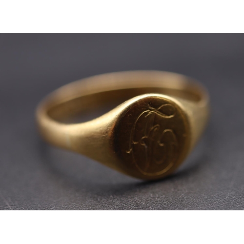 720 - An 18ct gold signet ring with engraved monogram, Size Q/R, 3.4 grams