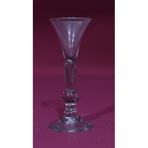 74 - An early 18th Century Balustroid wine glass with drawn trumpet bowl, ball knop and domed foot, circa... 