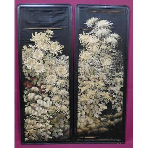 743 - A pair of Chinese black silk panels with allover floral and leaf decoration (some damage to silk), e... 