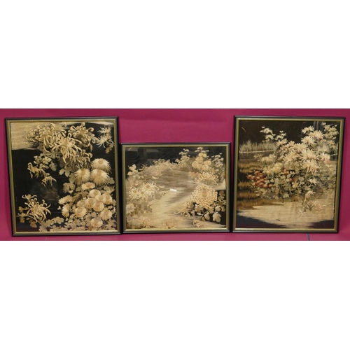 744 - 3 Chinese black silk framed panels depicting garden and floral decoration, in black and gilt frames,... 