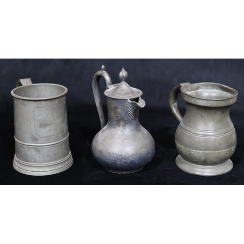 749 - An antique pewter pot-bellied tankard, a similar pewter tankard and a Britannia metal hot water jug ... 