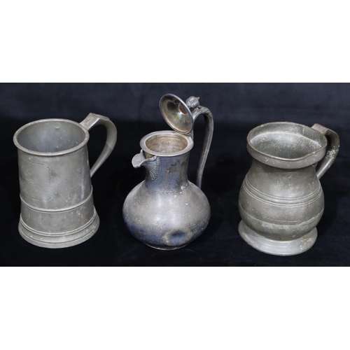 749 - An antique pewter pot-bellied tankard, a similar pewter tankard and a Britannia metal hot water jug ... 