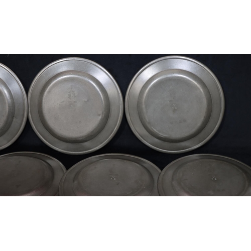 750 - A set of 11 antique pewter round plates, 23.6cm diameter