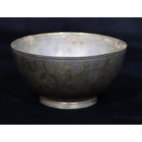 751 - An Eastern metal and inlaid silver round bowl with allover leaf and scroll decoration, 14.7cm diamet... 