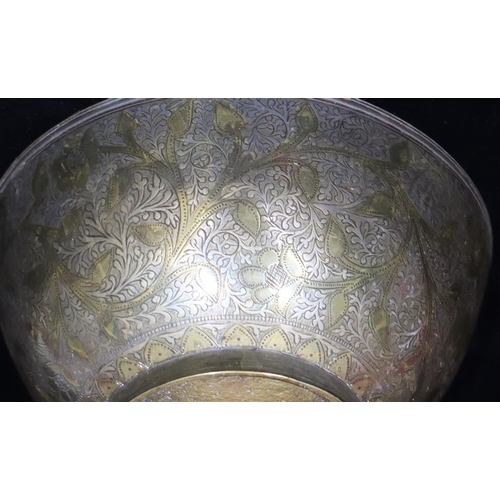 751 - An Eastern metal and inlaid silver round bowl with allover leaf and scroll decoration, 14.7cm diamet... 