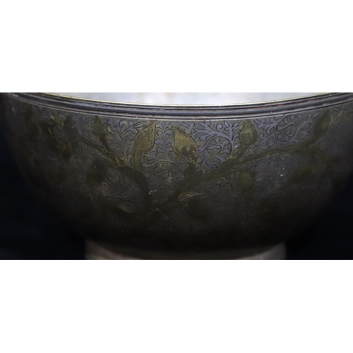 751 - An Eastern metal and inlaid silver round bowl with allover leaf and scroll decoration, 14.7cm diamet... 