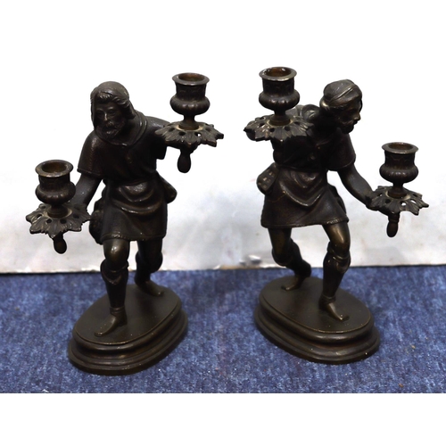 760 - A pair of bronze candlesticks in the form of a standing gentleman on oblong bases, 25cm high