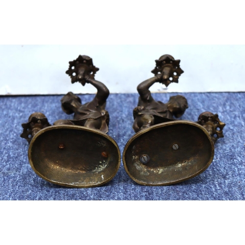 760 - A pair of bronze candlesticks in the form of a standing gentleman on oblong bases, 25cm high