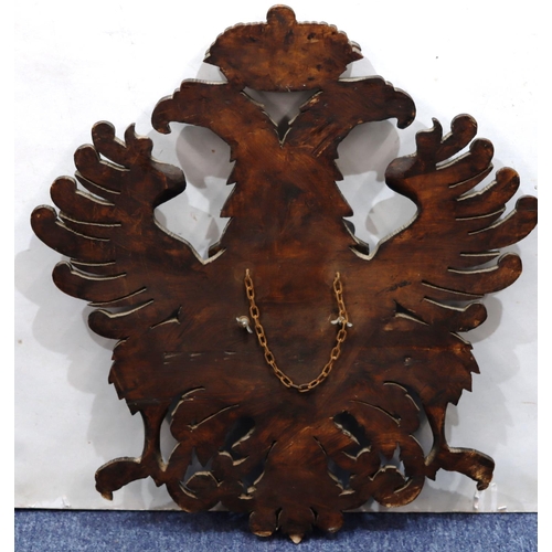 761 - A carved wooden hanging crest with eagle motifs, 84.5cm high, 58cm wide