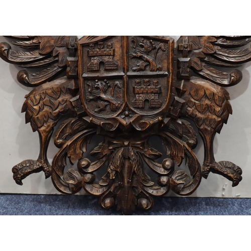 761 - A carved wooden hanging crest with eagle motifs, 84.5cm high, 58cm wide