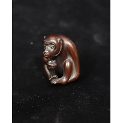 806 - A carved wooden netsuke of a monkey